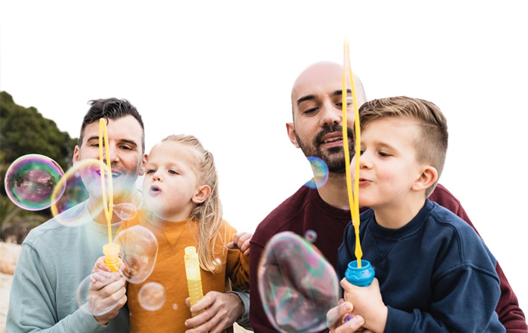 Young family playing with bubbles